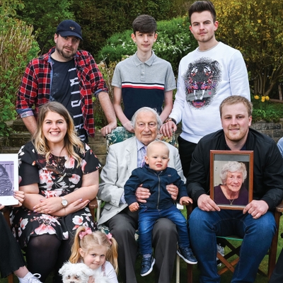   Rudi fled Berlin in 1937 with his parents who settled in Bradford. He is pictured with his grandchildren and great-grandchildren holding a portrait of his late wife Marianne, his book and a photograph of his cousin Daniel who did not survive the Holocaust.    - © Carolyn Mendelsohn