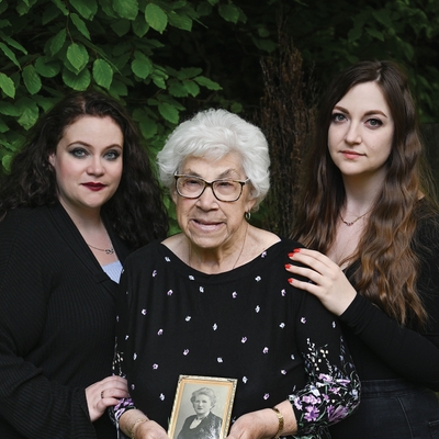   Liesel left Germany at the age of four in 1939. She settled in England and later married Terry with whom she had three children.     She has five grandchildren and two great-grandchildren.     She is pictured with her granddaughters Lauren &amp; Eleanor. She holds a photograph of her mother.    - © Carolyn Mendelsohn